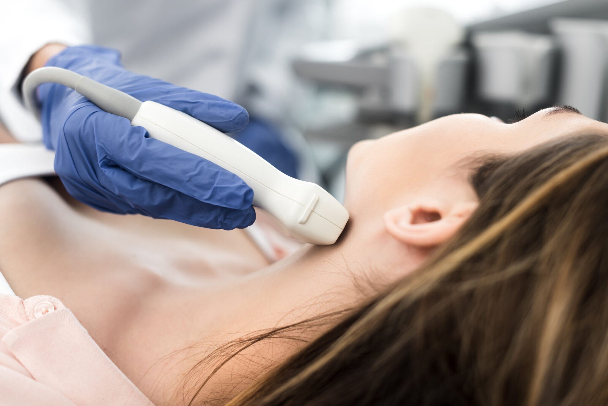 doctor-examining-thyroid-of-female-patient-with-ul-2021-09-01-14-42-23-utc-2048x1367