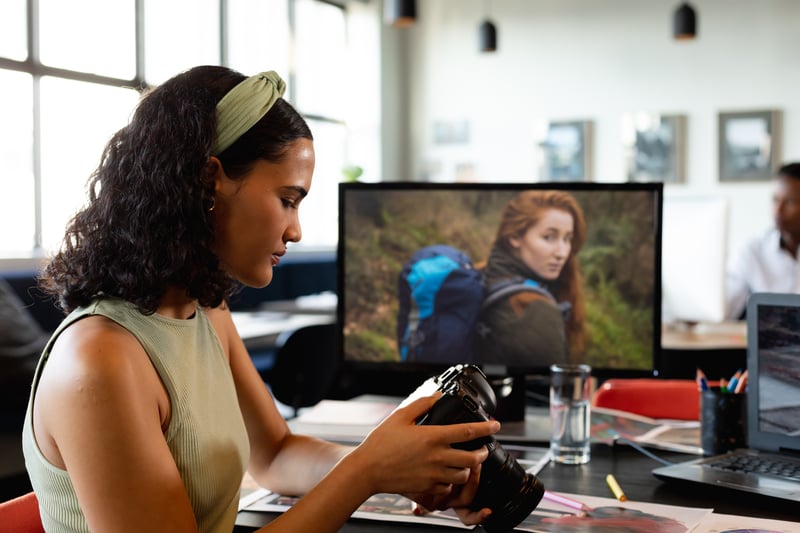 biracial-young-businesswoman-examining-camera-at-d-2023-11-27-05-13-03-utc